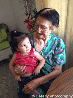 grandmother holding small child