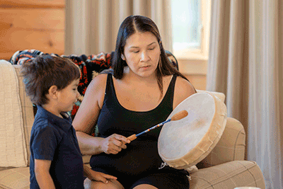 woman beating tribal drum